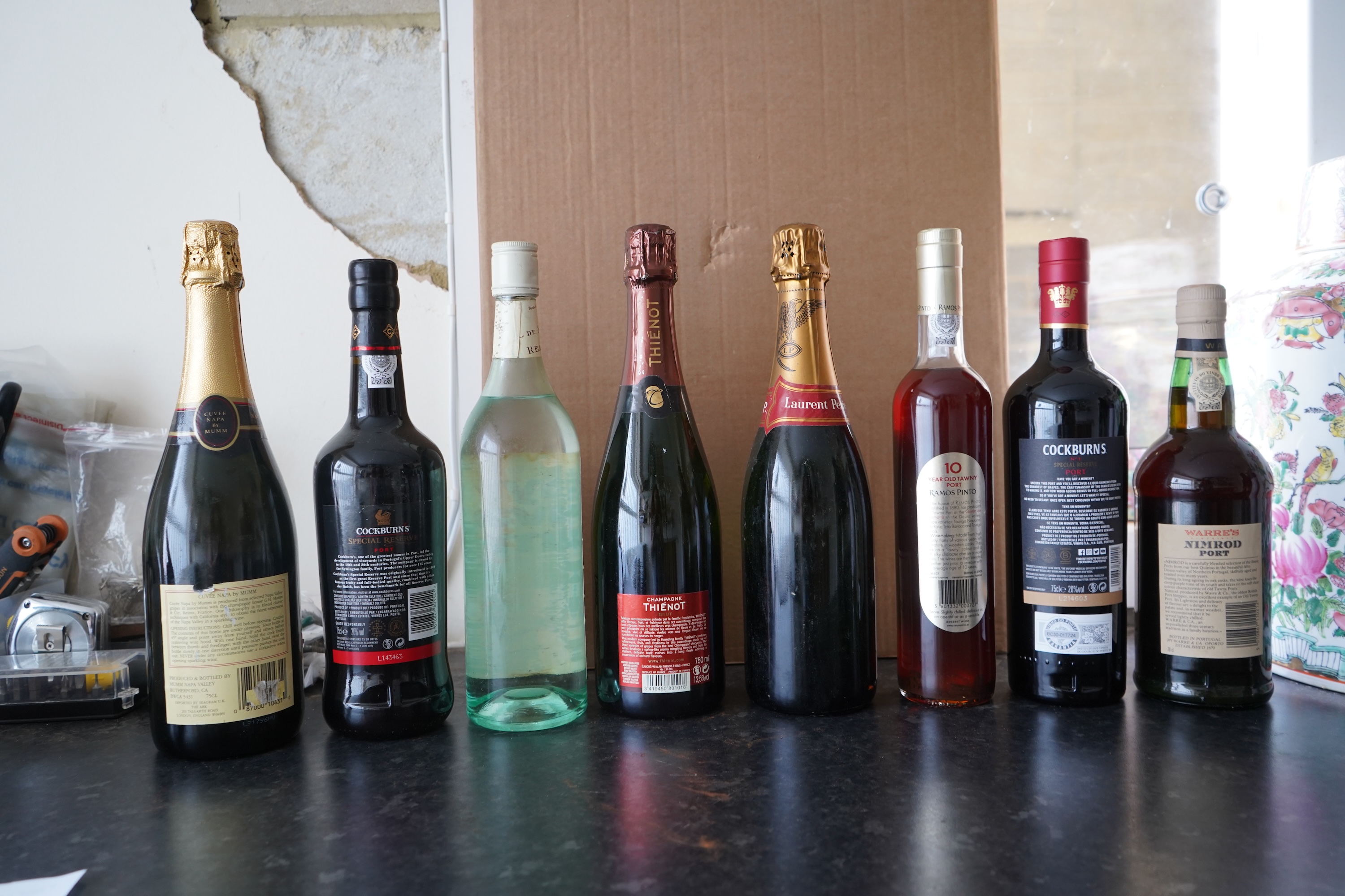 Eight bottles of champagne, port and rum to include Mumm, Laurent Perrier and Warres